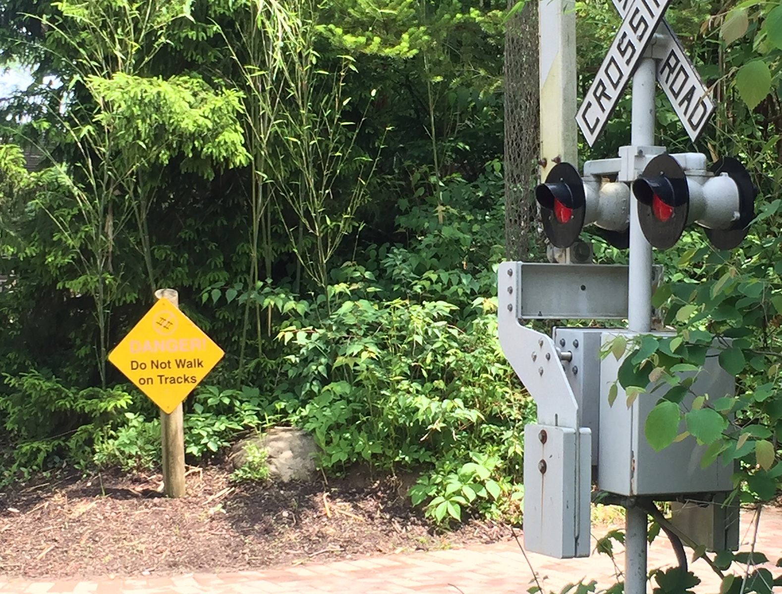 sun faded railroad crossing sign